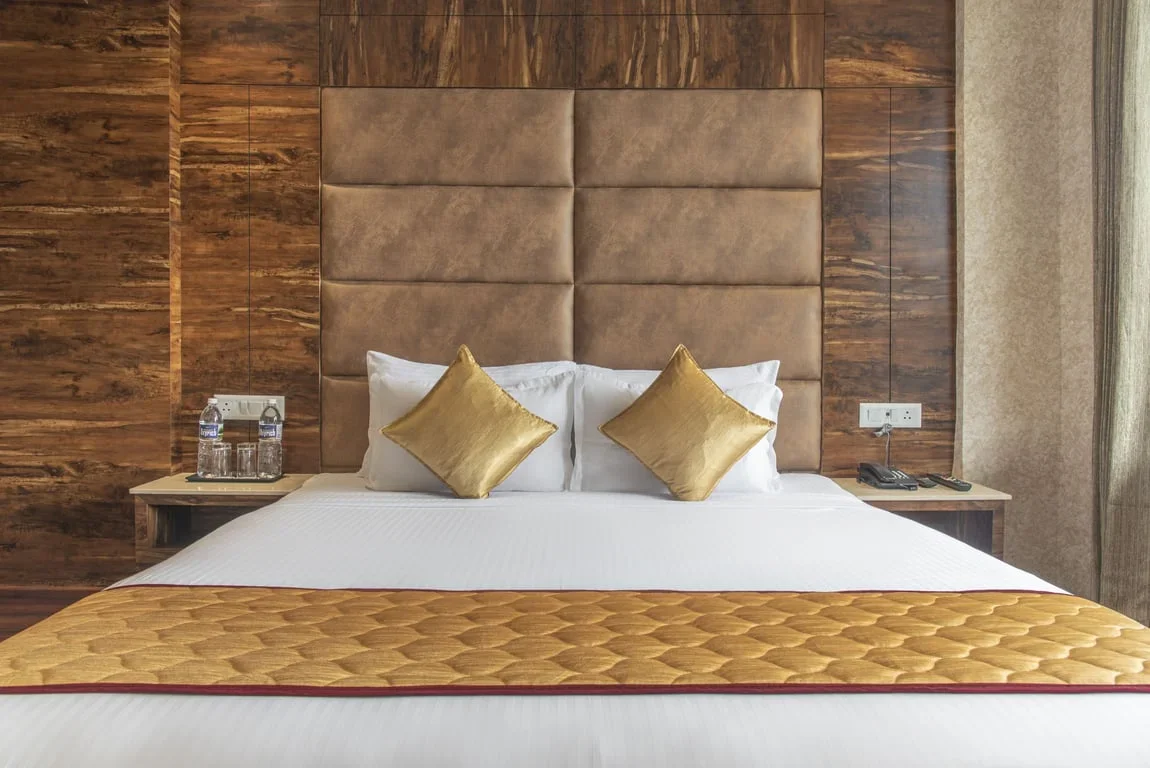 luxury hotel room bed setup at Alpine Holiday Inn, Kufri
